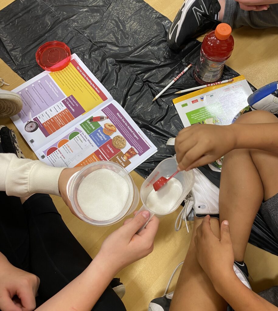 students measuring sugar